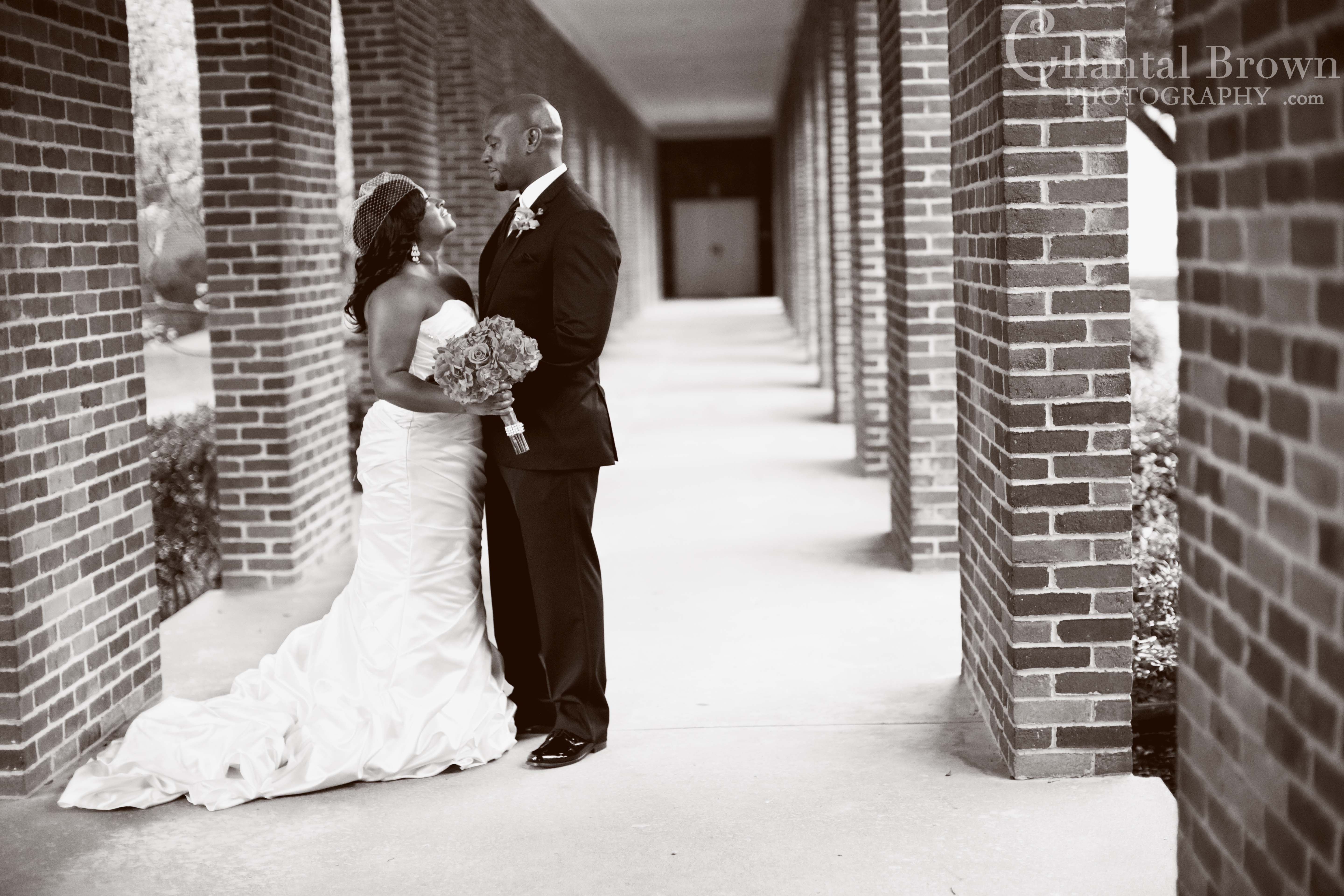 bride groom standing by brick stone wall at Royal Lane Church ceremony Dallas wedding Photographer